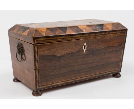 A 19th century rosewood and marquetry tea caddy: of sarcophagus outline. The shallow domed hinged lid with 'tumbling cube' ma