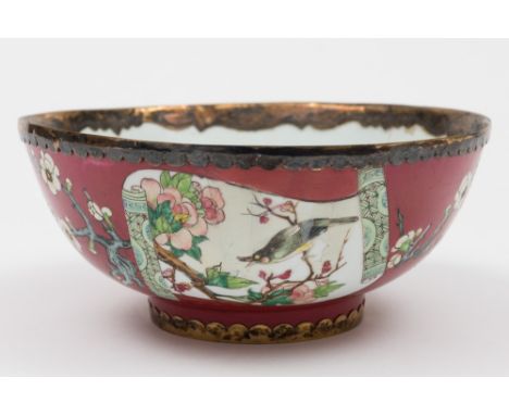 A Chinese ruby ground famille rose bowl: finely painted with scroll panels of birds amongst peony and other blooms within scr