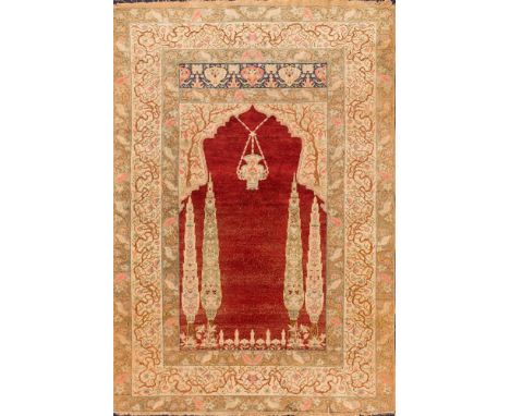 A Tabriz prayer rug:, the red mihrab with a design of a hanging lantern and cypress trees, the beige arch surround with a des