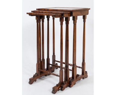 A nest of three early 19th Century mahogany rectangular occasional tables:, the moulded tops on ring turned dual column and t
