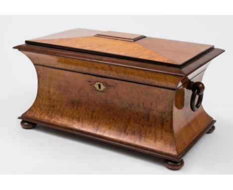 A 19th century satinwood tea caddy : of sarcophagus outline, the shallow domed hinged lid enclosing two lidded canisters and 