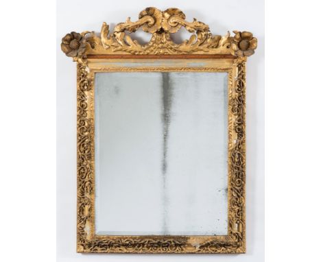 A late 19th Century giltwood and gesso rectangular mirror:, with pierced acanthus leaf and flowerhead shaped cresting, the be
