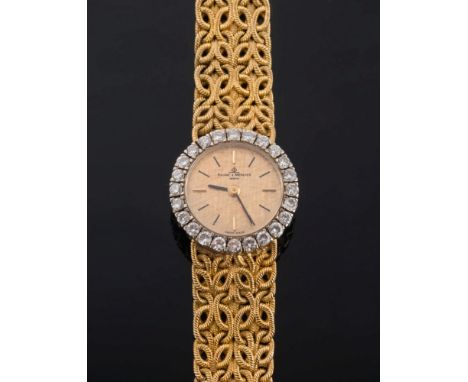 Baume & Mercier. A lady's 18ct gold and diamond wristwatch:, the signed circular, textured gold colour dial with baton marker