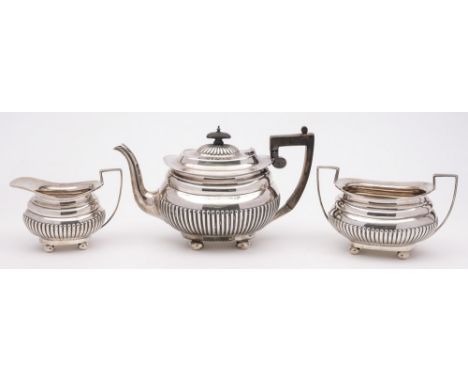 An Edward VII silver three-piece tea service, maker John & William Deakin, Sheffield, 1902: of barge shaped outline, with hal