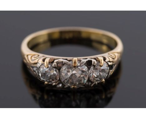 A late 19th century gold and diamond three-stone ring: with round old brilliant-cut diamonds weighing approximately 0.25ct, 0