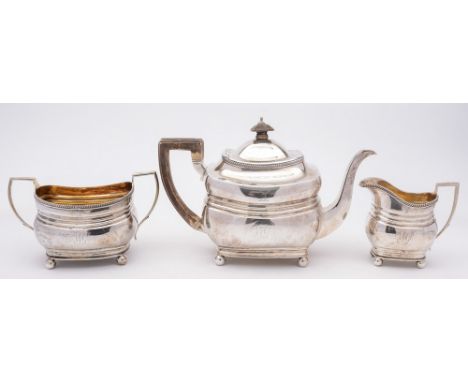 A matched three-piece silver tea service, various maker's and dates: crested and monogrammed, of barge shaped outline with ga