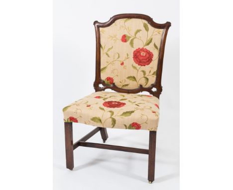 A George III carved mahogany side chair:, in the Chippendale manner, the cartouche shaped upholstered panel back in scroll de