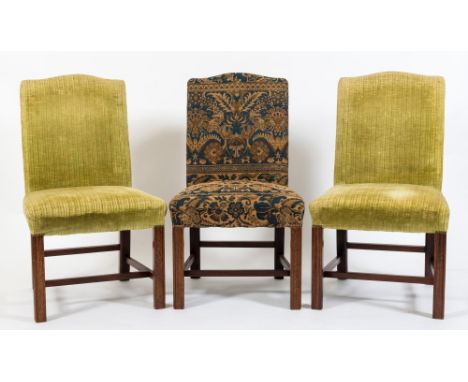 A set of six mahogany and upholstered side chairs in the Georgian taste:, with arched stuff over backs and seats on moulded s