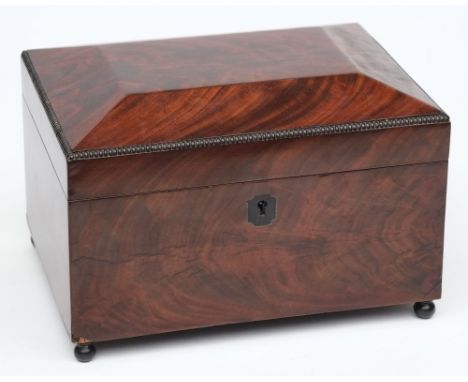 A 19th century mahogany tea caddy:.of sarcophagus outline, with shallow domed hinged lid enclosing two lidded canisters and c