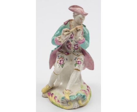 A Derby 'Pale Family' figure of a piper: wearing a pink tricorn hat, turquoise jacket and floral decorated breeches, on shell
