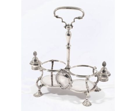 A George II oil and vinegar cruet stand, maker T.W, London, 1748: the stand with loop carrying handle and ring turned stem wi