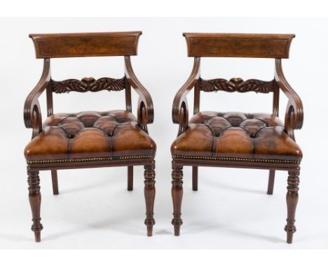 A pair of Regency carved mahogany elbow chairs:, the backs with reeded curved bar top rails and shaped horizontal splats deco