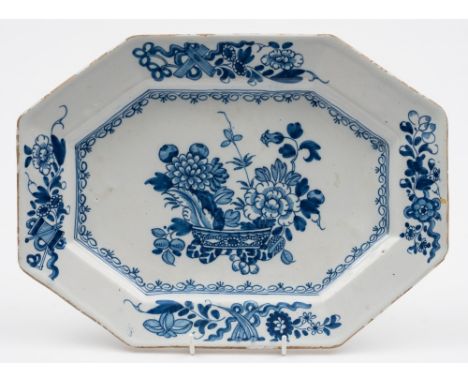 A Liverpool delft tureen stand or serving dish: of octagonal form painted in blue with an Oriental jardiniere containing chry