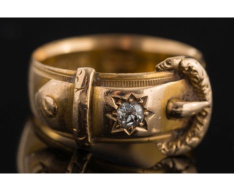 An 18ct gold diamond 'buckle' ring: with hallmarks for Birmingham, star set with an old-cut diamond estimated to weigh 0.10ct