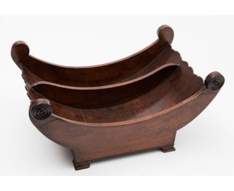 A 19th century mahogany cheese coaster: of crescent -shaped outline, with ring turned roundels, raised on swept feet with bra