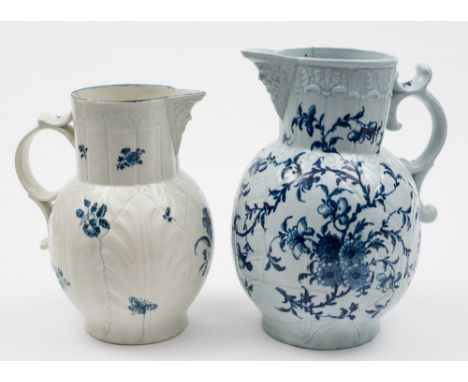A large Worcester blue and white cabbage leaf jug and a similar later jug: the first with mask head spout and painted with th