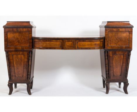 A Regency mahogany twin-pedestal sideboard:, of bowed breakfront outline, the centre fitted with two drawers to the panelled 