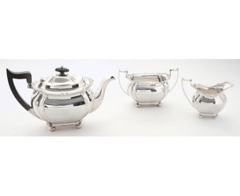 A George V silver three-piece tea service,  maker Joseph Ridge, Sheffield, 1927/28: crested, of barge-shaped outline with flu