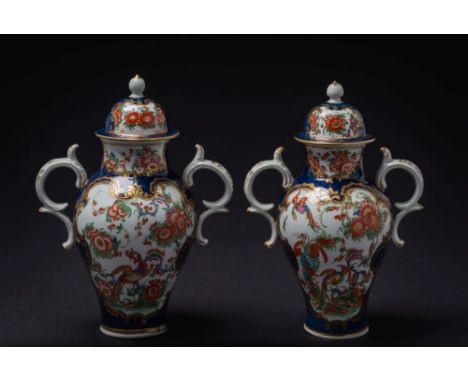 A pair of Worcester scale-blue baluster vases: of small size with double scroll handles, painted in the Kakiemon style with a