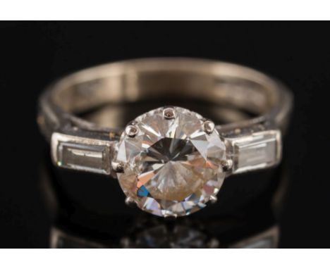 An 18ct white gold and diamond single stone ring:, the circular, brilliant-cut diamond estimated to weigh 2.2cts, between bag