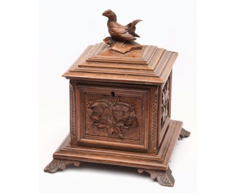 A Black Forest-style square tea caddy:, the hinged lid surmounted by a cockerel finial, having foliate decoration to the side