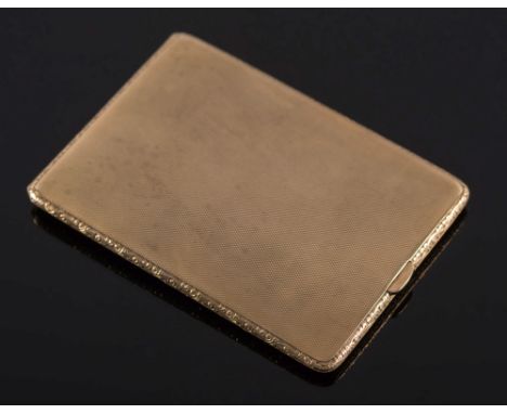 A 9ct gold rectangular cigarette case: with engine turned decoration and scroll chased border, Birmingham 1927, approximately