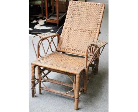 A Vintage Rattan Reclining Armchair, with pull-out footstoolStructurally sound, heavy wear and some unwinding to the rattan, 