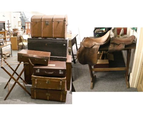 An Estate Built Pine Saddle Stand, and two brown leather saddles; together with a dome top trunk, four suitcases, a pine blan