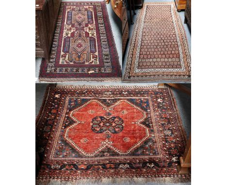 A Kurdish Rug, the charcoal field of stlyliced boteh enclosed by triple narrow borders, 256cm by 105cm and An Afshar Baluch (