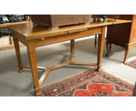 A Light Oak Extending Draw Leaf Dining Table, first half of the 20th century, with parquetry quatrered top having wide crossb