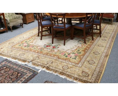 A Gol Farang Carpet, the light camel field with central floral medallion enclosed by mustard borders of acanthus vines, 430cm