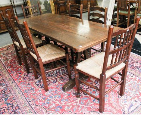 A Refectory Dining Table, 187cm by 76cm by 75cm; together with a set of six oak ladder back rush seated dining chairs