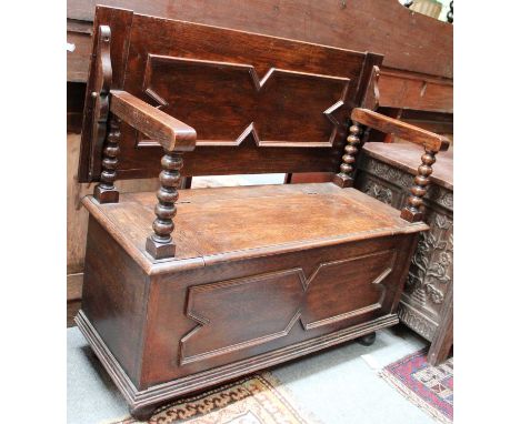 An Oak Monks Bench, with moulded panels and bobbin turned support, 106cm by 43cm by 98cm