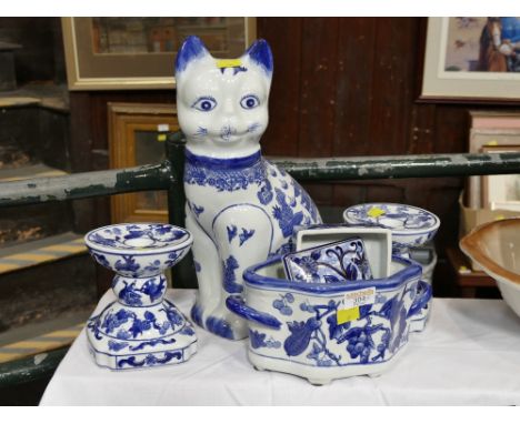 Oriental style blue and white cat, pair of candlesticks, two handled planter and lidded pot 
