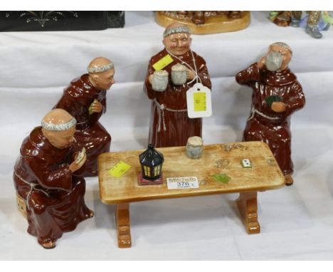 Ceramic figure of monks drinking ale around table 