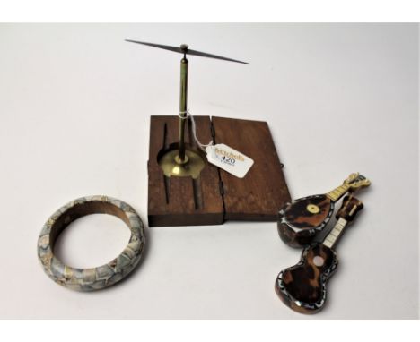 Small brass instrument in wooden case, two inlaid tortoiseshell guitars and mosaic bangle 