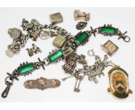 A mixed lot comprising a hallmarked silver charm bracelet, a modernist white metal bracelet set with enamel panels, a Victori