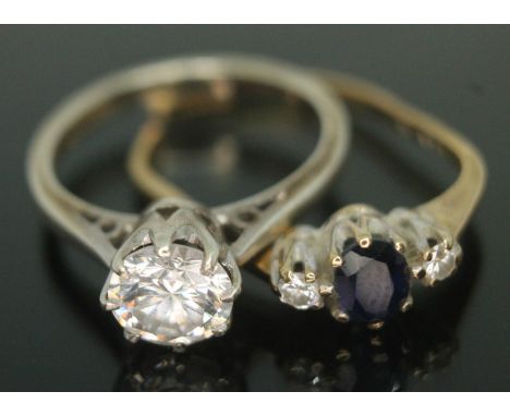 A hallmarked 9ct white gold ring set with a cubic zirconia size J and another ring set with two diamonds and a blue stone (da