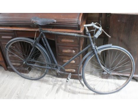A vintage single speed bicycle with Brooks saddle.  