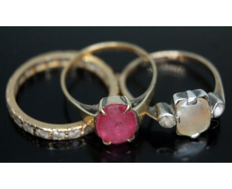 A group of three rings comprising an eternity band unmarked, a ring set with pink paste marked '9ct' and a ring set with moth