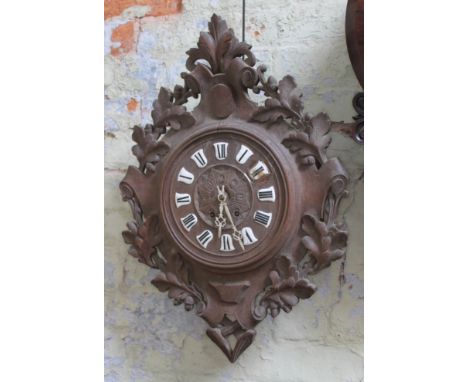 A 19th century Black Forest wall clock with enamel Roman numerals, length 65cm.  