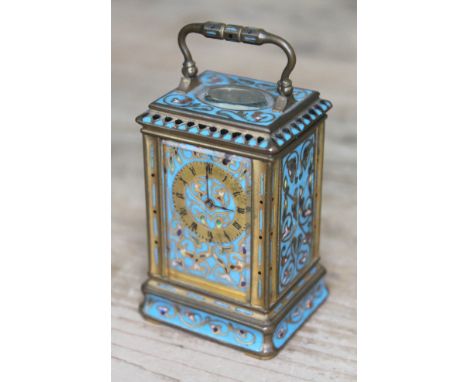 A French miniature champleve enamel and gilt brass carriage clock, circa 1900, maker's mark 'DG' and numbered 42120, with key