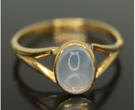 A yellow metal ring set with a moonstone cabochon, indistinctly marked '22c', gross wt. 3.01g, size Q.&nbsp;Condition - minor