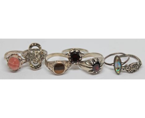 A group of seven rings comprising a hallmarked silver ring set with a rhodochrosite cabochon, six others, various marks.  