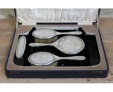 A cased cut glass backed silver dressing table set, William Hair Haseler, Birmingham 1928.  