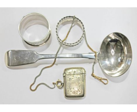 A mixed lot of silver comprising a ladle and two serviette rings, together with a silver plated vesta case on two colour chai