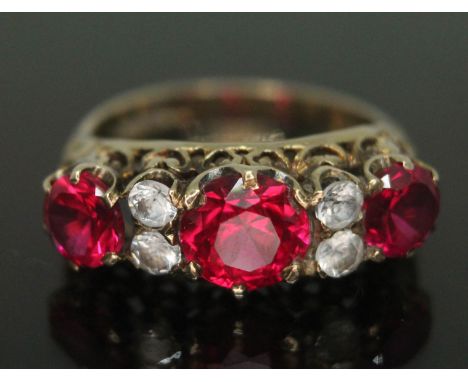 A hallmarked 9ct gold ring set with synthetic rubies and colourless paste, gross wt. 3.15g, size K.  