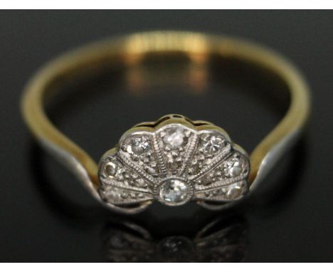 An Art Deco diamond cluster ring, millegrain fan shape setting 10mm x 6mm, marked '18ct &amp; PT', gross wt. 2.36g, size P.&n