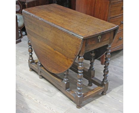 An 18th century oak gate leg table with bobbin legs, min. length 103cm, width 46cm &amp; height 76.5cm.  