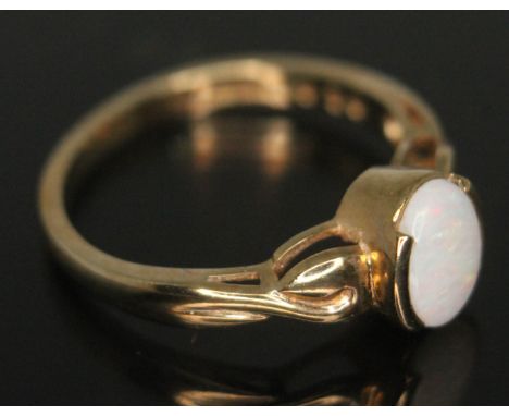 A hallmarked 9ct gold ring set with a precious opal cabochon, gross wt. 2.57g, size O.  Condition - good, minor wear only.